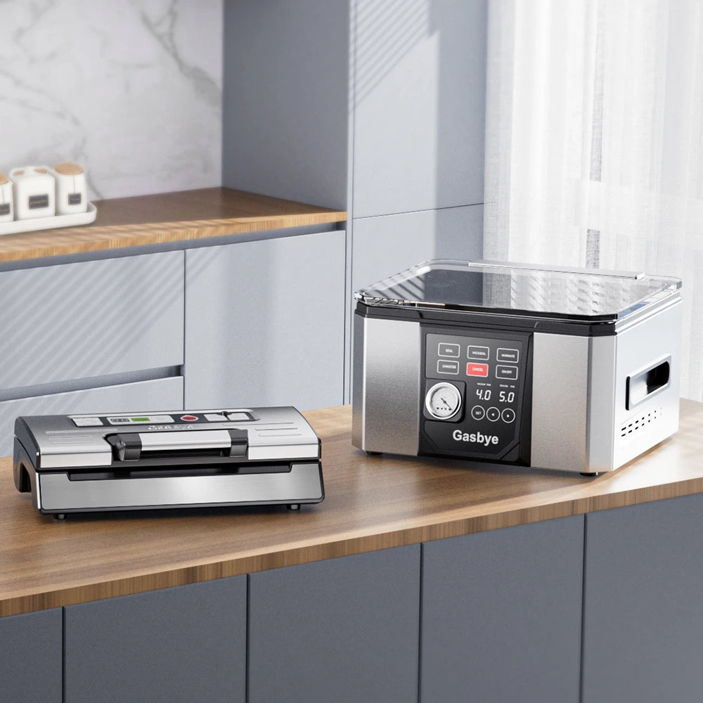 Two vacuum sealers on a kitchen counter with a modern kitchen background